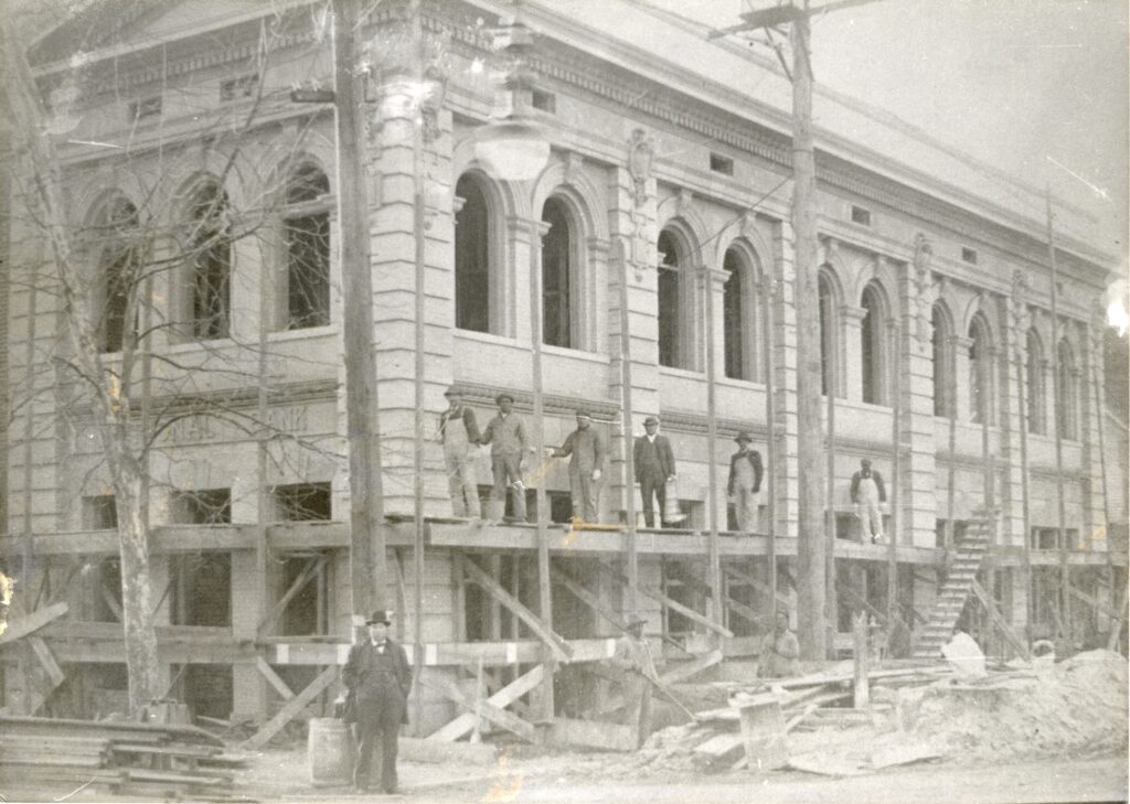 Men stand on scaffolding for repairs of a building