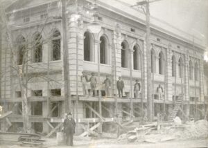 Men stand on scaffolding for repairs of a building