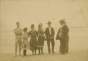 Six people standing on the beach