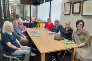 The members of the New Dawn Inspirational Book Club sit at a table at the Goldsboro Library