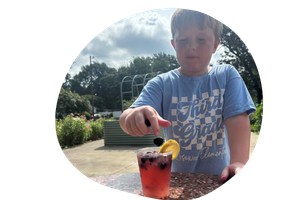 Sprout Scouts – lemonade a boy drops blackberries in his lemonade